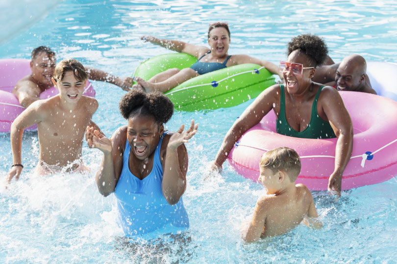 Happy kids splash in pool.