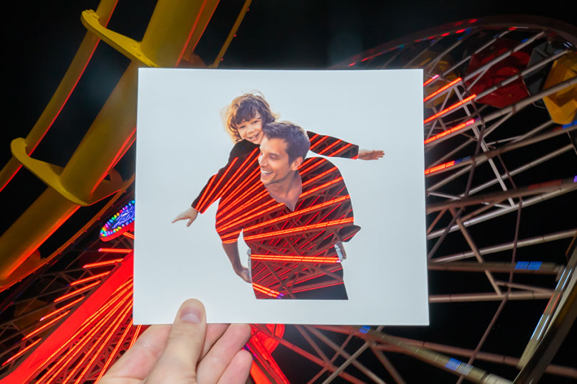 Father and son image superimposed over Ferris wheel.