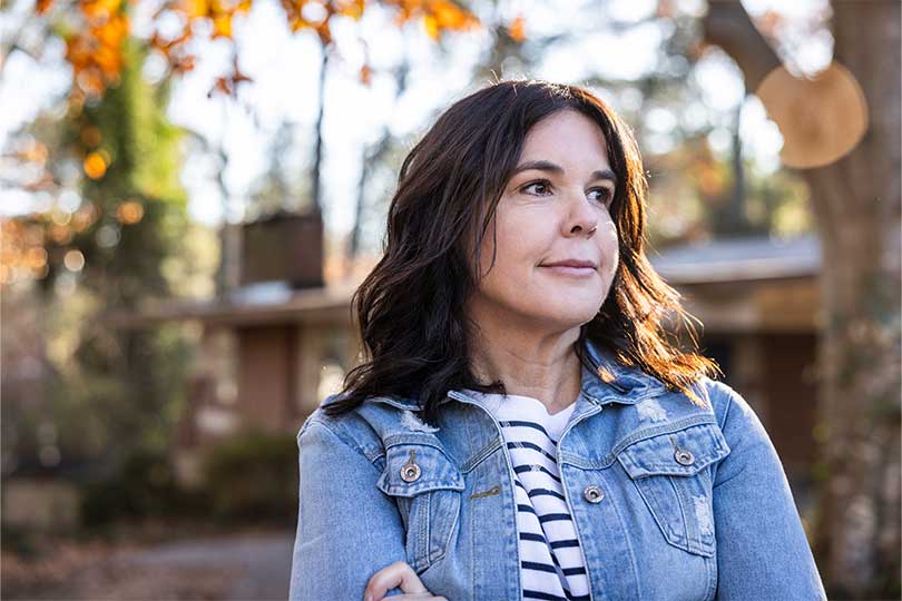 A woman thinking about the differences between menopause and perimenopause.