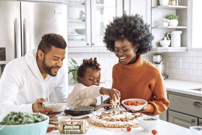 Family enjoys food at table.