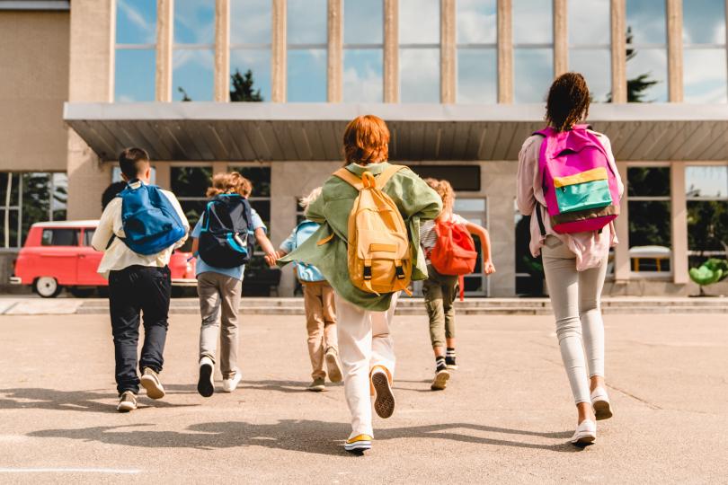 Kids run to enter school.