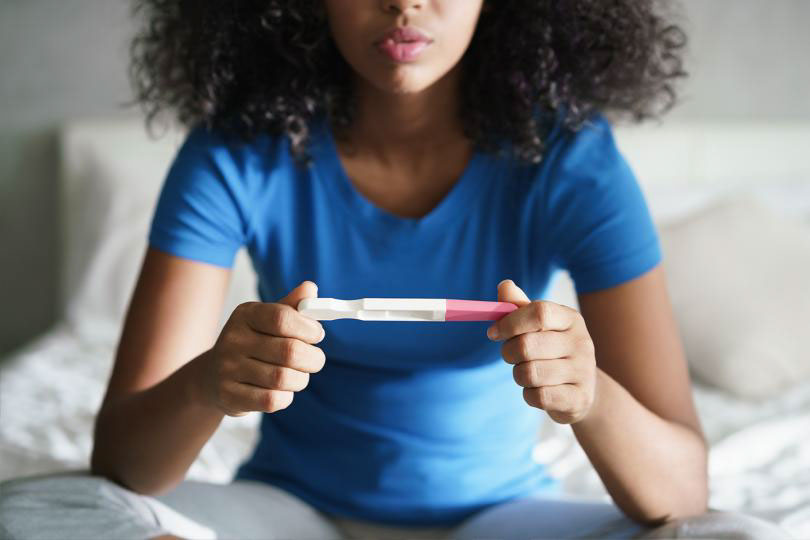 Woman awaits pregnancy test results.