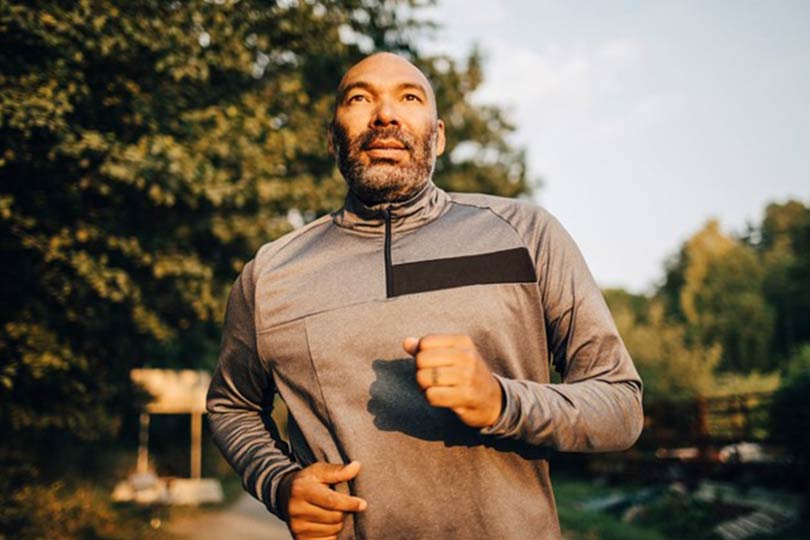 A man going for a run outside to help improve heart health and reduce heart disease risk.
