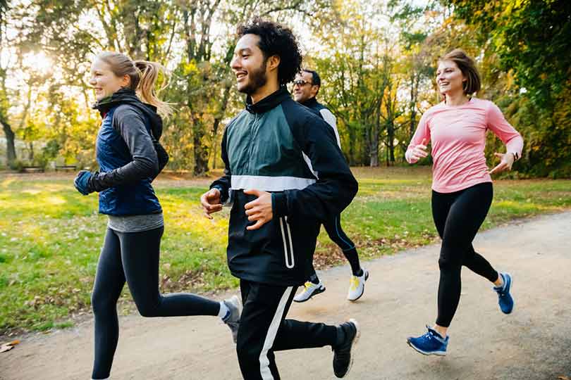 A group of people running outside, practicing wellness habits for pancreatic health.
