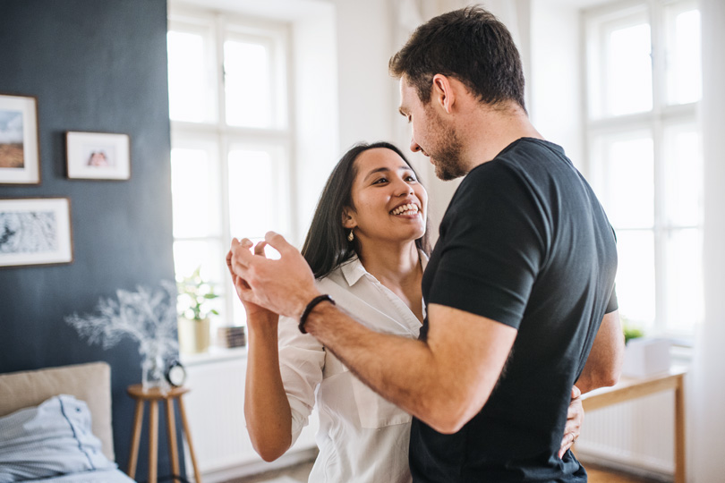 A man and woman dance together, holding hands, representing intimacy and the importance of STI awareness, including chlamydia and gonorrhea.