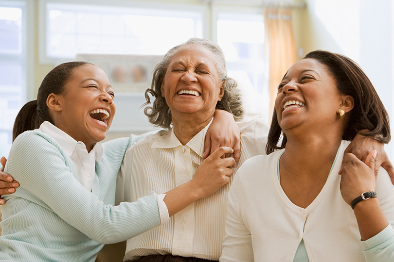 Three women embracing and celebrating their health.