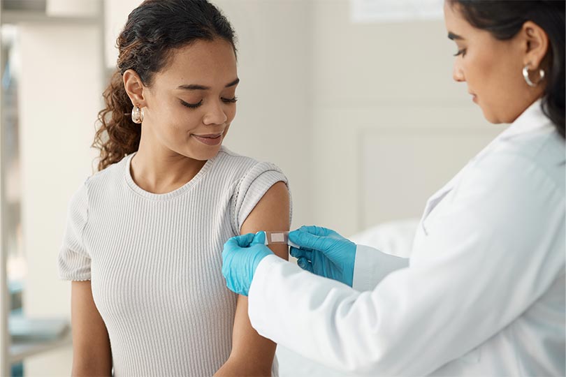 A woman visiting her healthcare provider to receive vaccinations for international travel.