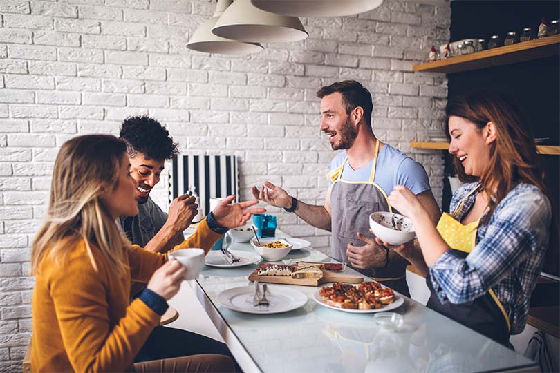 A group of men and women eating a meal together, discussing the blood type diet.