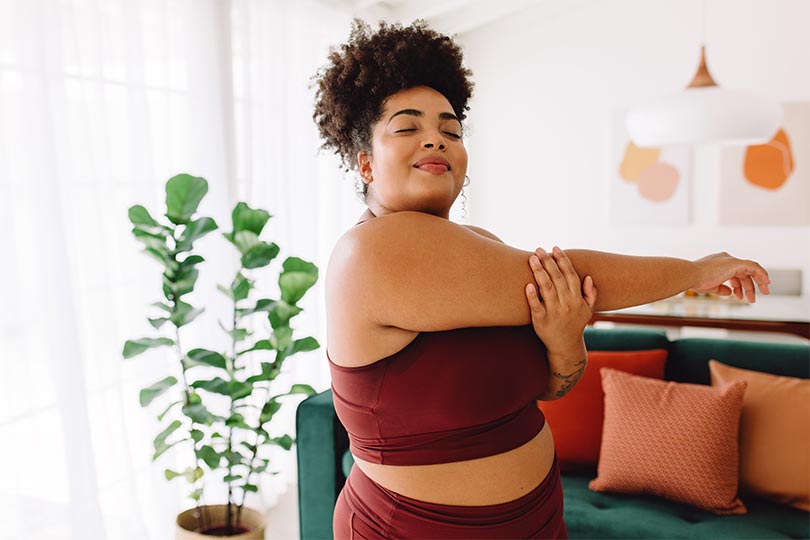 A woman stretching and thinking about the role of DHEA-S in hormonal health.
