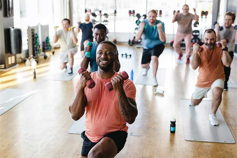 A group of men exercising in a workout class, a healthy habit that can help with maintaining healthy testosterone levels