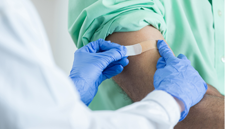 A doctor administers a vaccination to a patient in a clinical setting, ensuring proper care and attention.  
