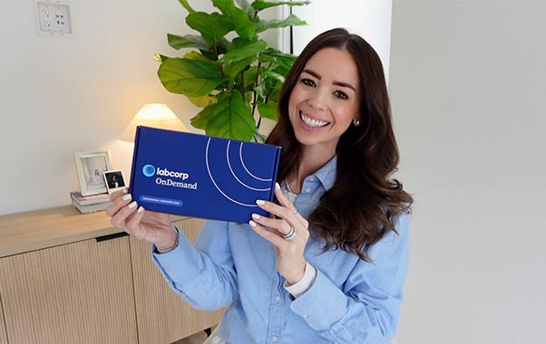A woman holding labcorp ondemand broucher
