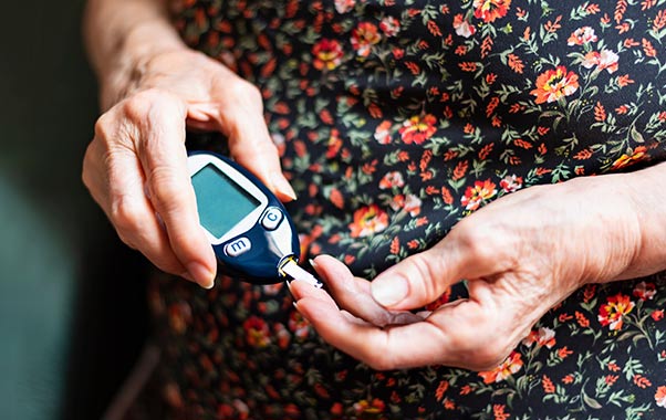 A person using a glucometer
