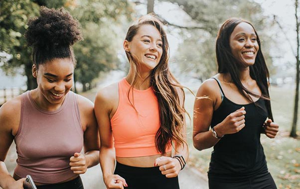 Two healthy young females running and staying active for women’s health.