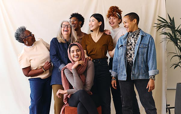 A group of women posing and talking about their reproductive health.