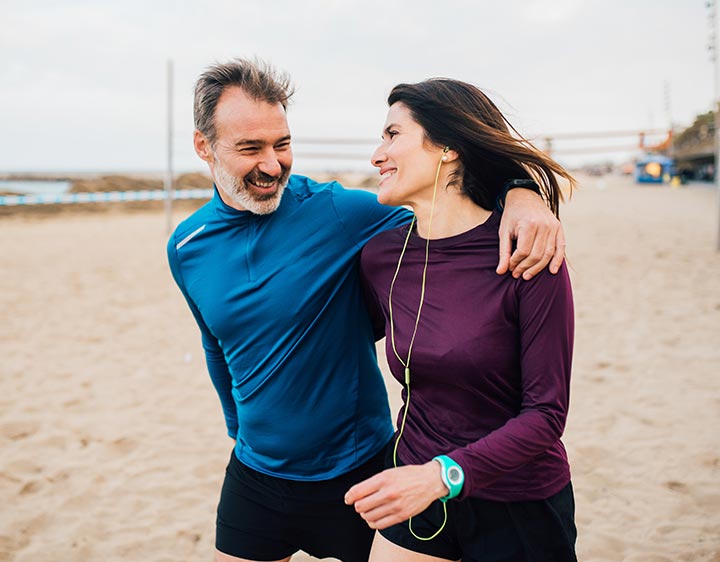 Man and woman jogging outdoors representing heart health and wellness lifestyle choices related to ApoB testing.