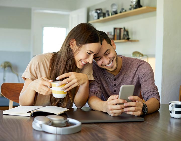 the man and woman looking at the phone