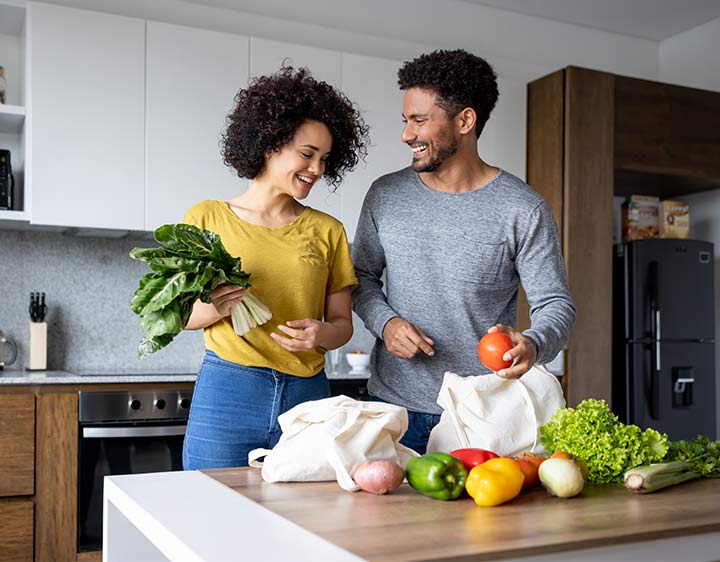 Couple with nutritious groceries to promote healthy heart.