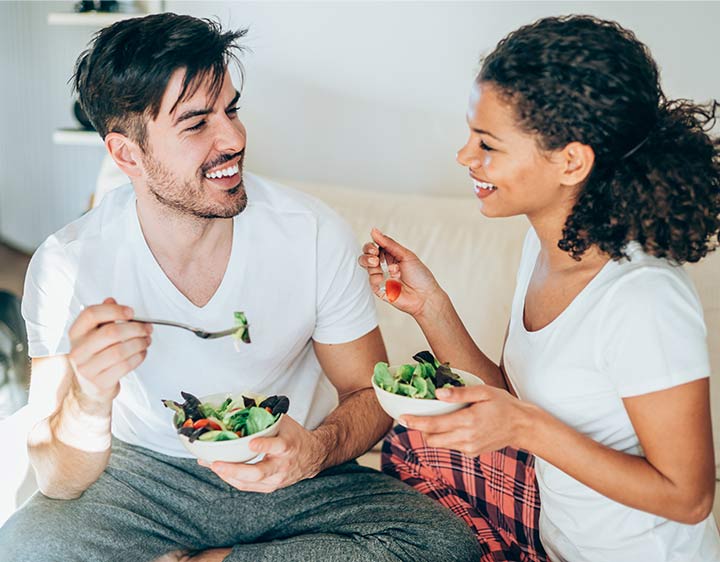 Man and woman eating nutritious food