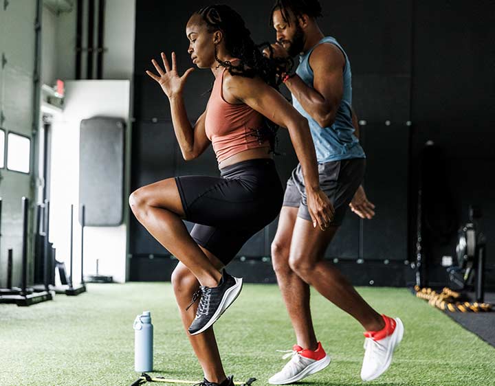 Woman and man exercising at a gym