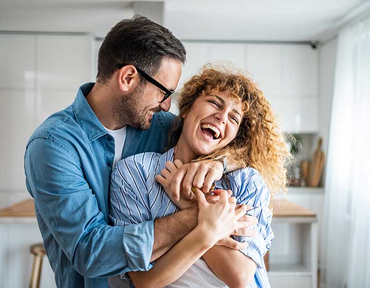 A happy couple inside their home