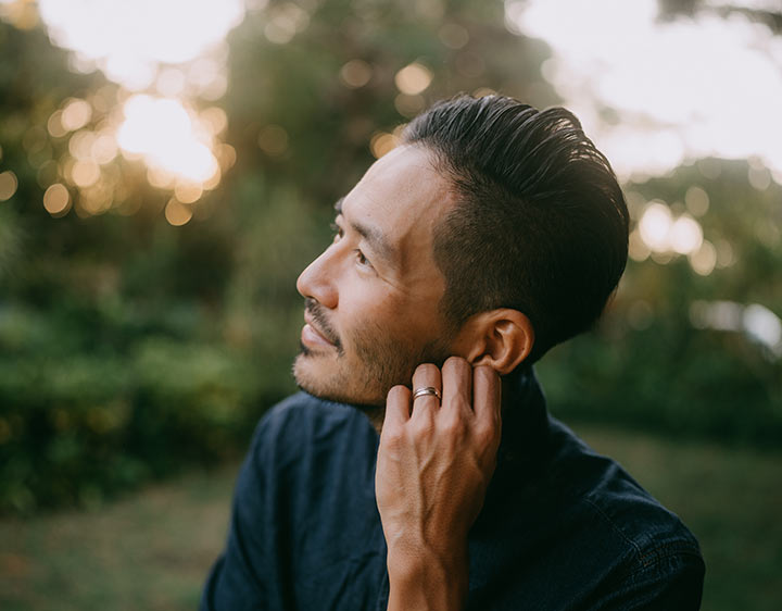 Healthy man looking into sunny sky.