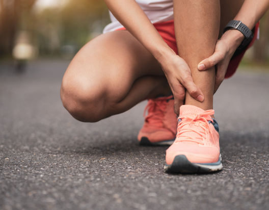 Jogger massages own ankle.