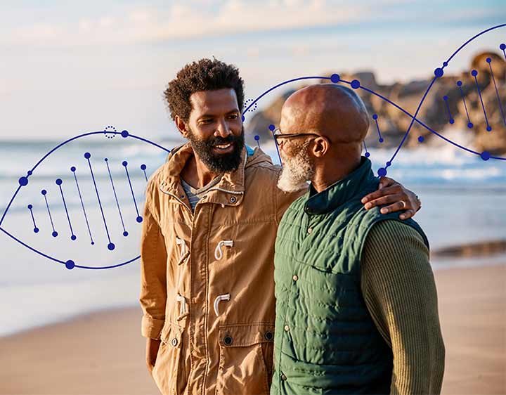 Two men are happily looking at each other while discussing genetic health.