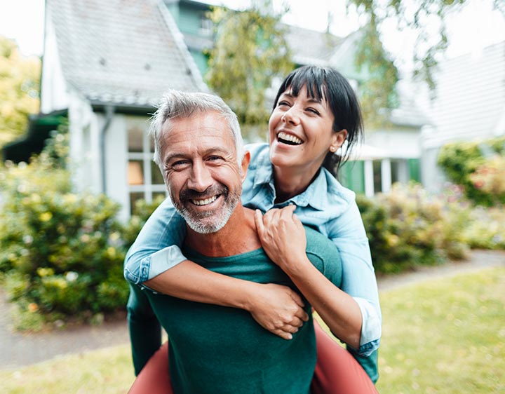 A happy man and woman outside after learning more about their metabolic health.