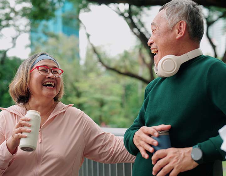 A man and woman are exercising and socializing outside