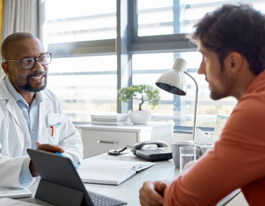 Man discusses prostate cancer screening with healthcare provider. 