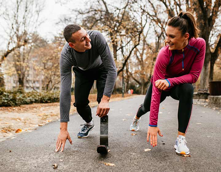 Young man and woman active outdoors maintaining healthy thyroid function.