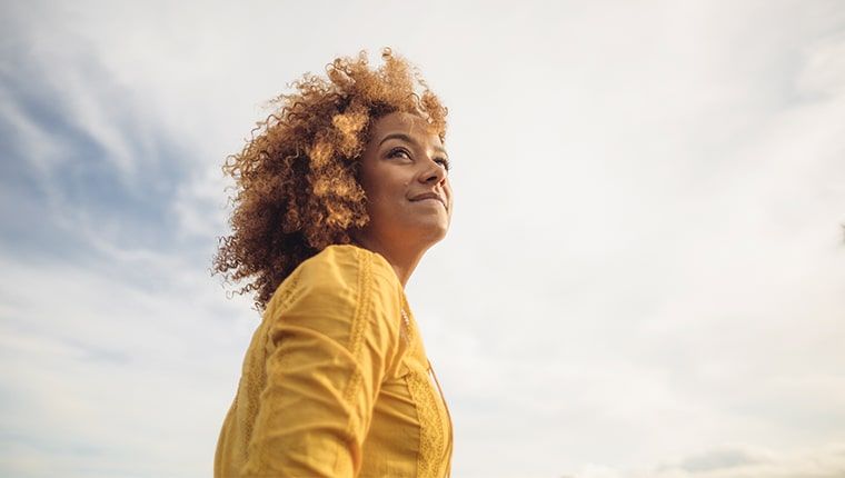 A female looking up at the sky thinking about her AMH hormone level.