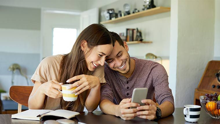Man and woman looking at the phone.