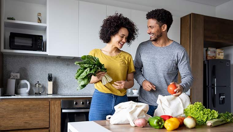 Couple with nutritious groceries to promote healthy heart.