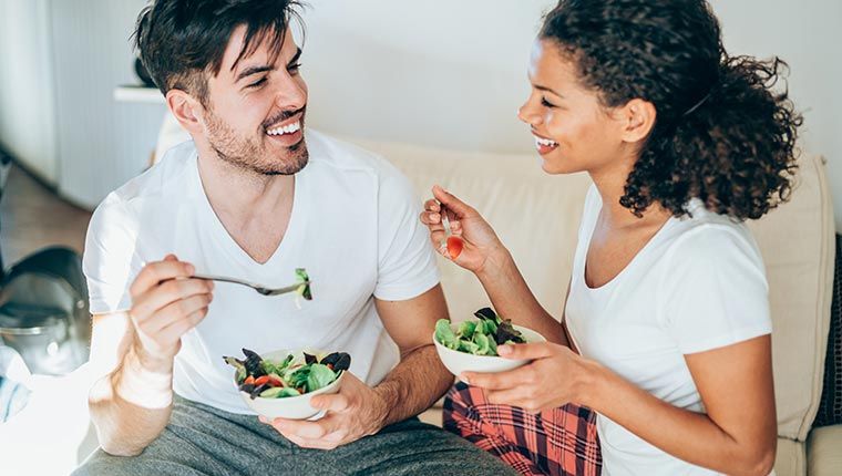 Man and woman eating nutritious food.