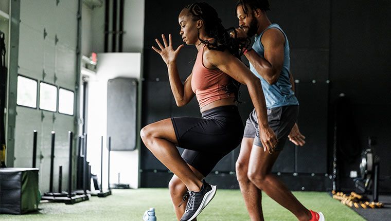Woman and man exercising at a gym.