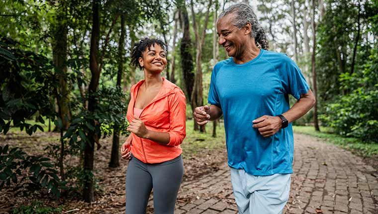 Man and woman exercising outdoors.