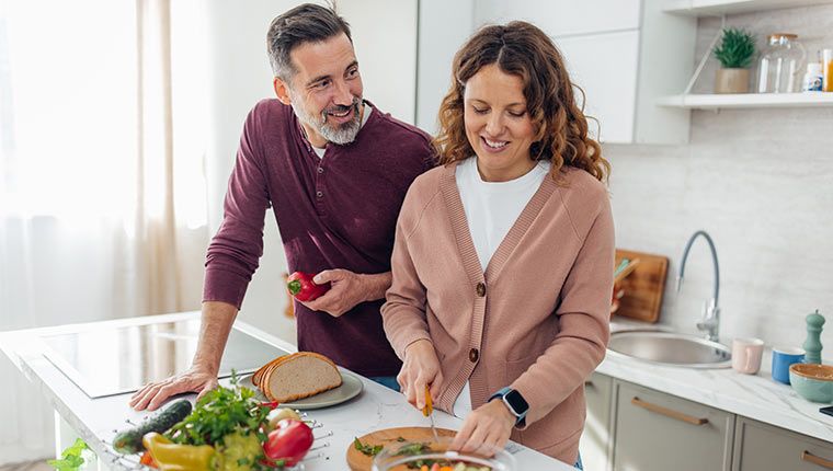 Couple preparing nutritious, gut-friendly meal.