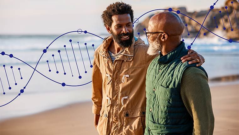 Two men are happily looking at each other while discussing genetic health.