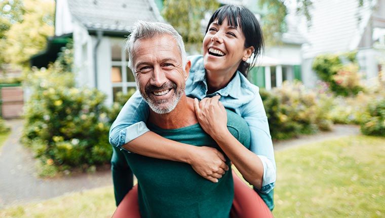 A happy man and woman outside after learning more about their metabolic health.