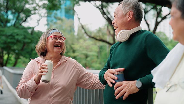 A man and woman are exercising and socializing outside.