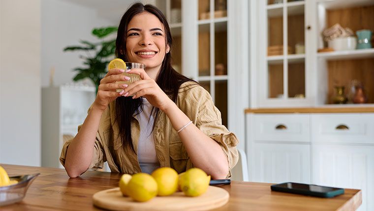 Woman drinking juice checking on health.