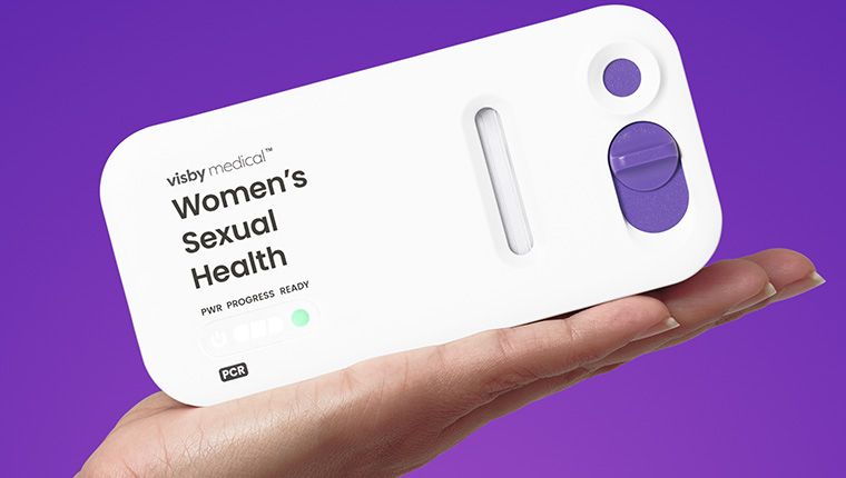 The Visby Rapid PCR At-Home Female STI Test being held in a womans hand.